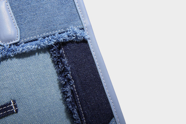 Structured patchwork denim tote bag with frayed panel seams, dual top handles, and silver-tone hardware, detail view 22