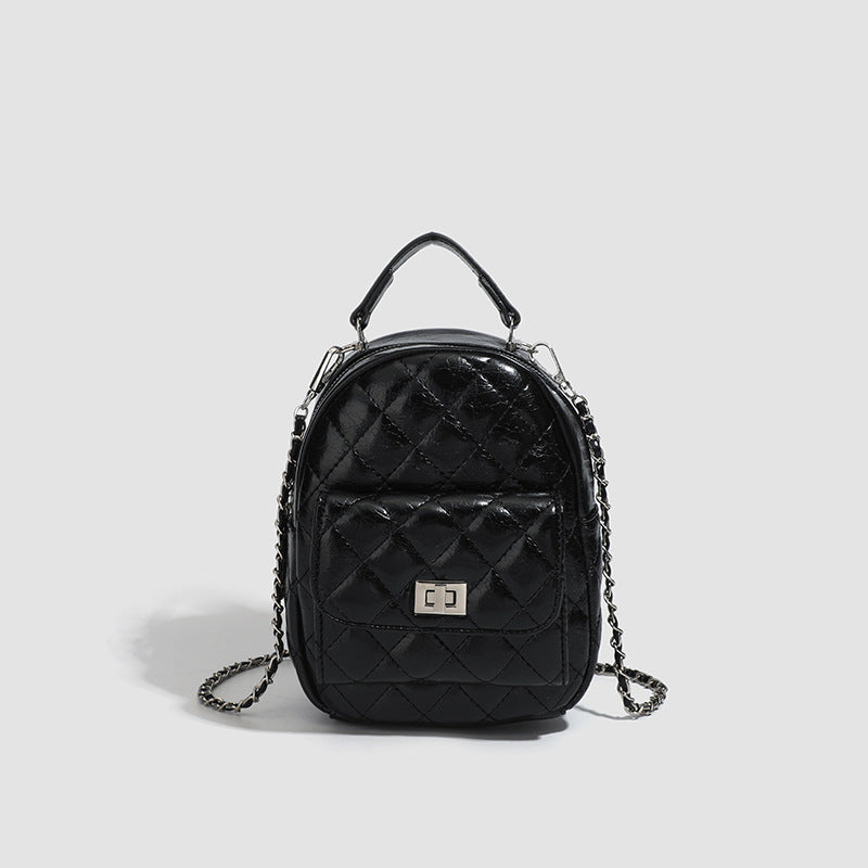 Quilted leather-look backpack purse with chain strap and turn-lock front pocket, detail view 10