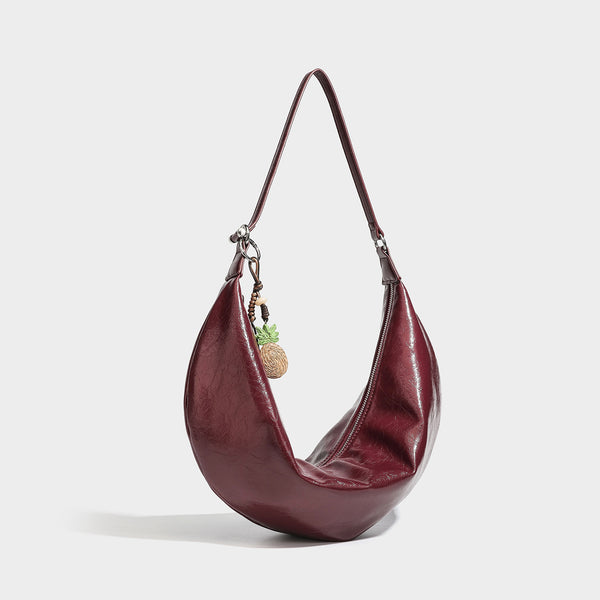 Lässige sichelförmige Hobo-Schultertasche aus glänzender, geknautschter Lederoptik mit schmalem Riemen, silberfarbenem Ringbeschlag und
