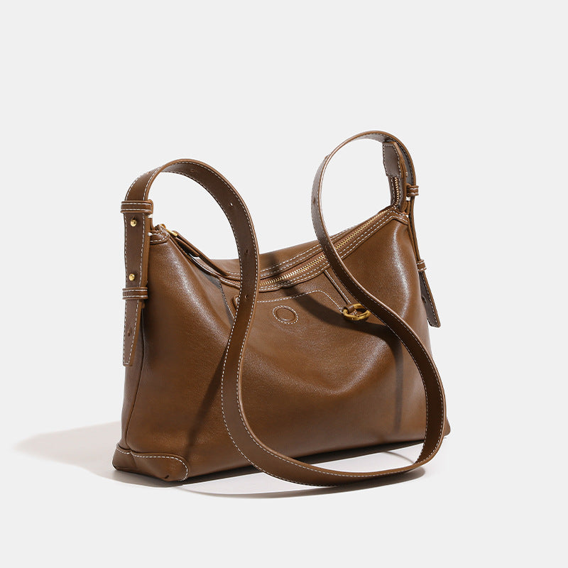 Smooth leather-look hobo bag with gold-tone ring hardware, contrast stitching, top handle and adjustable crossbody strap
