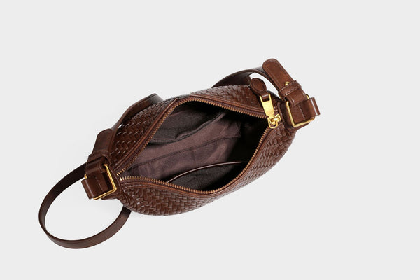 Small glossy basket-weave hobo shoulder bag in brown with knotted top handle, flap accent pocket, and gold-tone hardware