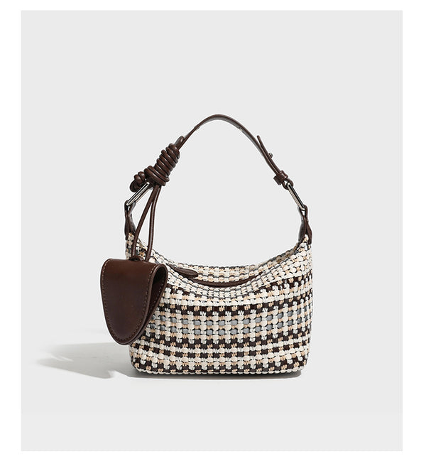Small crescent shoulder bag in black-and-white woven textile with smooth black leather-look trim, zip-top closure, knotted