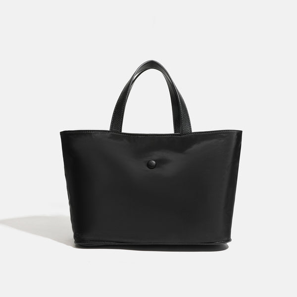 Structured lightweight nylon tote bag with textured double top handles and snap-button front detail, detail view 8