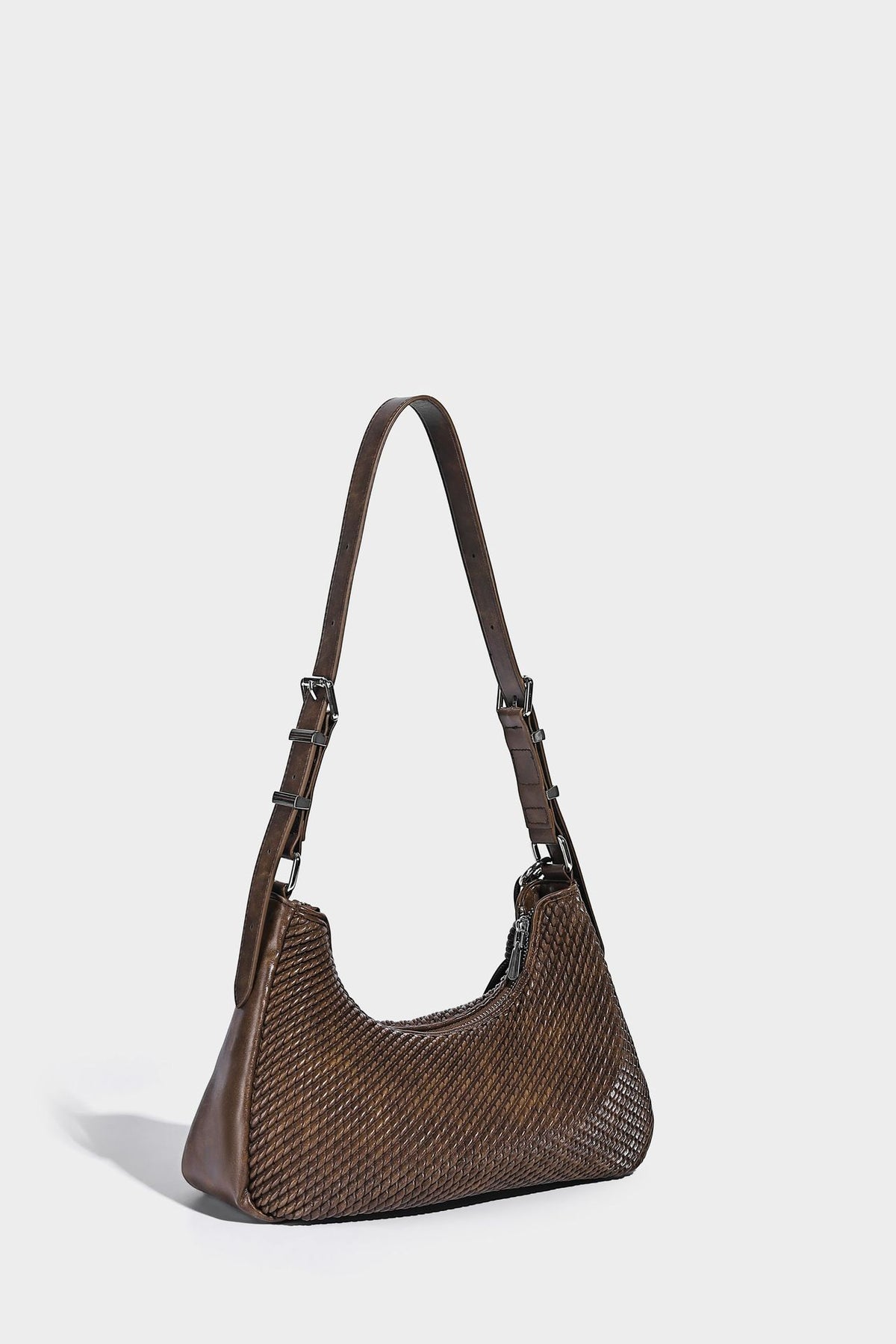Woven crescent hobo shoulder bag with smooth side panels, zip-top closure, silver-tone charm hardware, and adjustable, detail