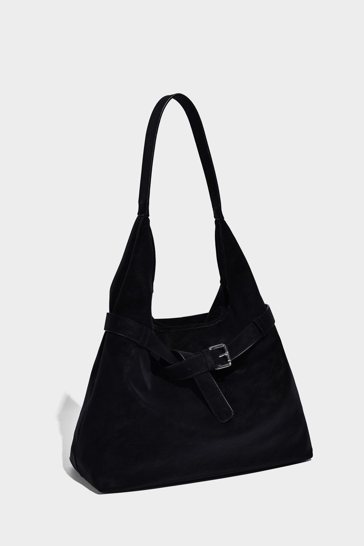 Slouchy oversized shoulder tote bag with matte textured finish, wrap-around buckle strap, and detachable front zip pouch