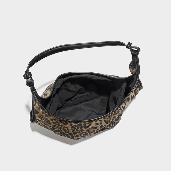 Slouchy brown leopard jacquard hobo tote bag with black leather-look trim and single shoulder strap, shown with black, detail