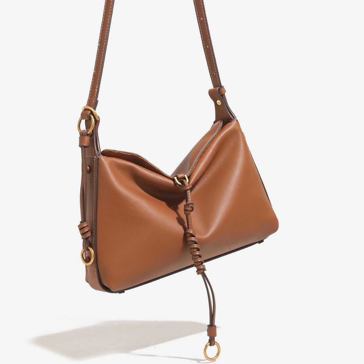 Slouchy crescent hobo bag in smooth matte leather-look finish with knotted cord base detail and antique gold-tone ring