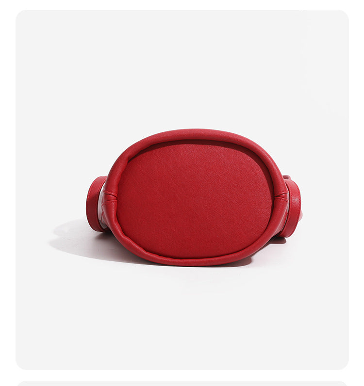 Large leather-look bucket tote bag with dual top handles and adjustable crossbody strap, detail view 19
