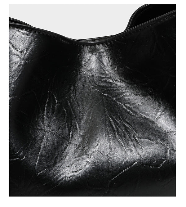 Black glossy crinkled leather-look convertible shoulder tote bag with gold gourd-shaped emblem hardware and detachable