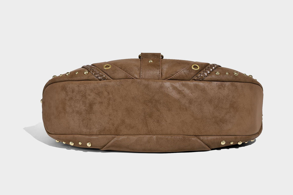 Slouchy crescent hobo bag in matte brown suede-like finish with gold-tone studs, grommets, braided top handle, tassel side