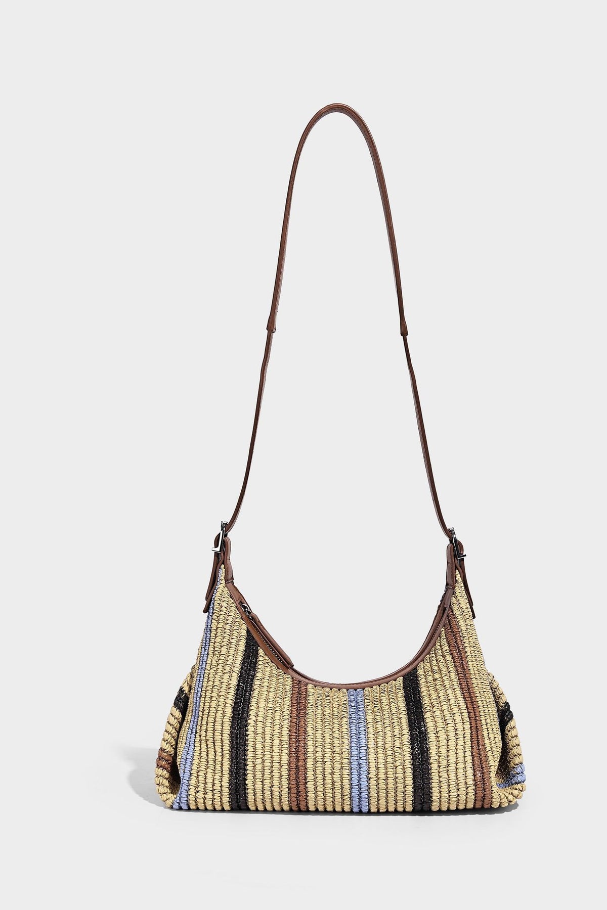 Slouchy woven straw hobo shoulder bag with beige, black, brown, and blue vertical stripes and brown leather-look trim, detail