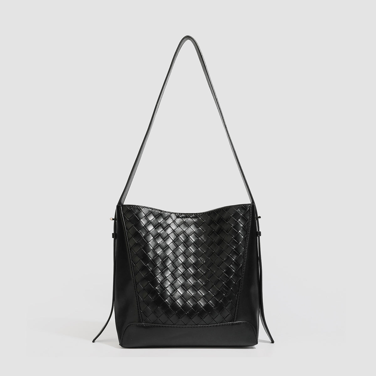 Large black bucket shoulder bag with diamond woven leather-look front panel, smooth side panels, magnetic snap closure, and