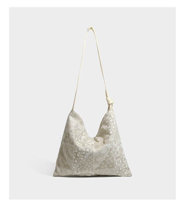 Weich fallende Hobo-Schultertasche aus Canvas mit botanischem Print, langem geknotetem Riemen und Reißverschluss oben, Detailansicht 10