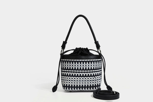 Small structured woven checker bucket bag with braided top handle, drawstring closure, and silver-tone hardware in black