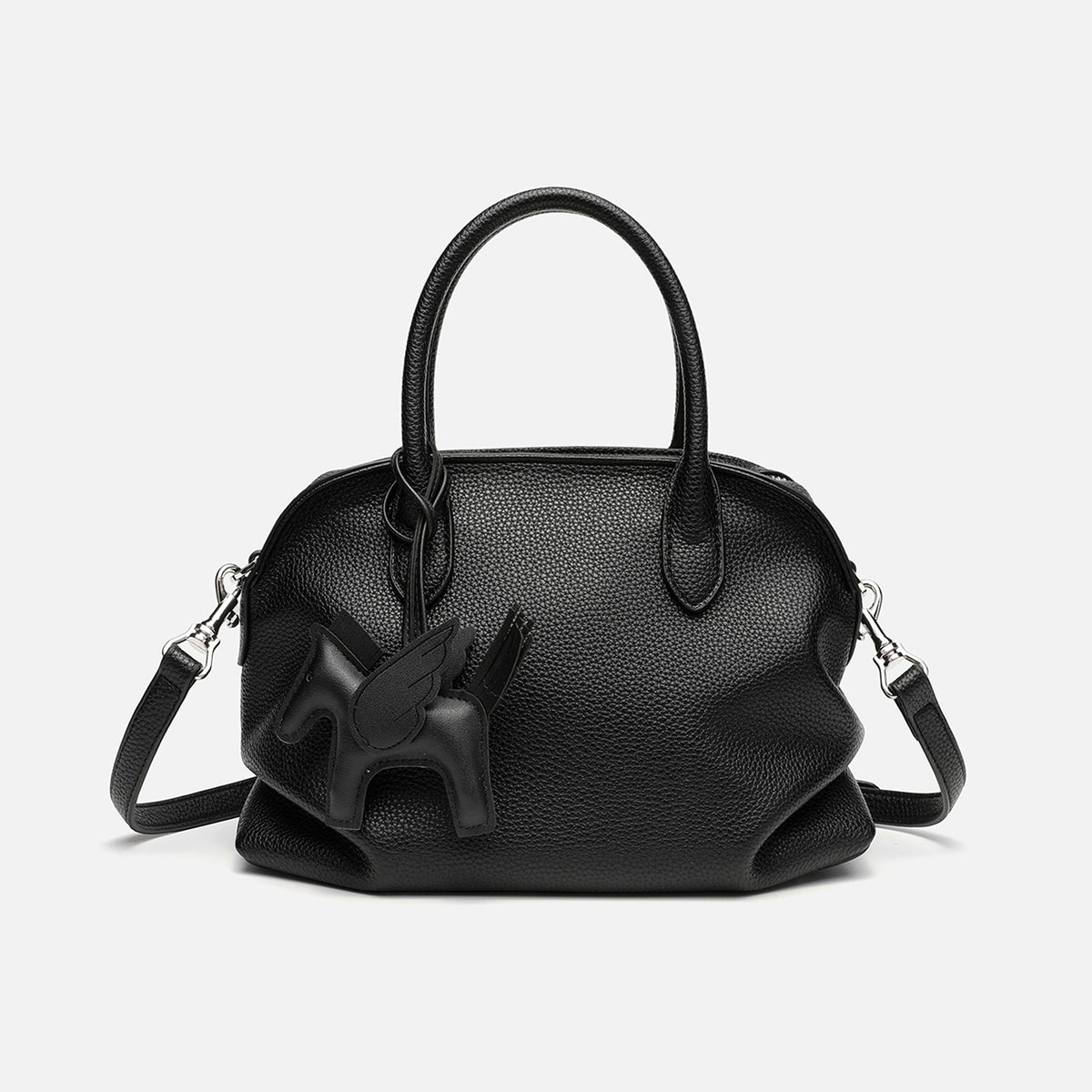 Rounded dome shell handbag in pebbled leather-look finish with twin top handles, zip closure, decorative horse charm, and