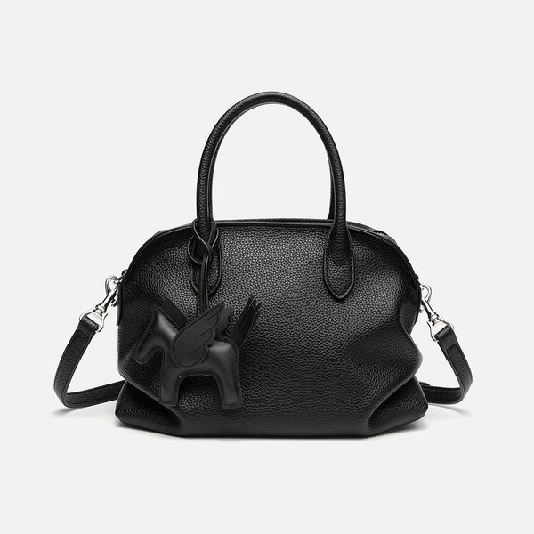 Rounded dome shell handbag in pebbled leather-look finish with twin top handles, zip closure, decorative horse charm, and