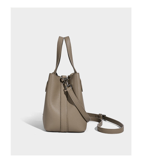 Compact pebbled bucket tote bag with elephant charm, twin top handles, and detachable crossbody strap, detail view 10