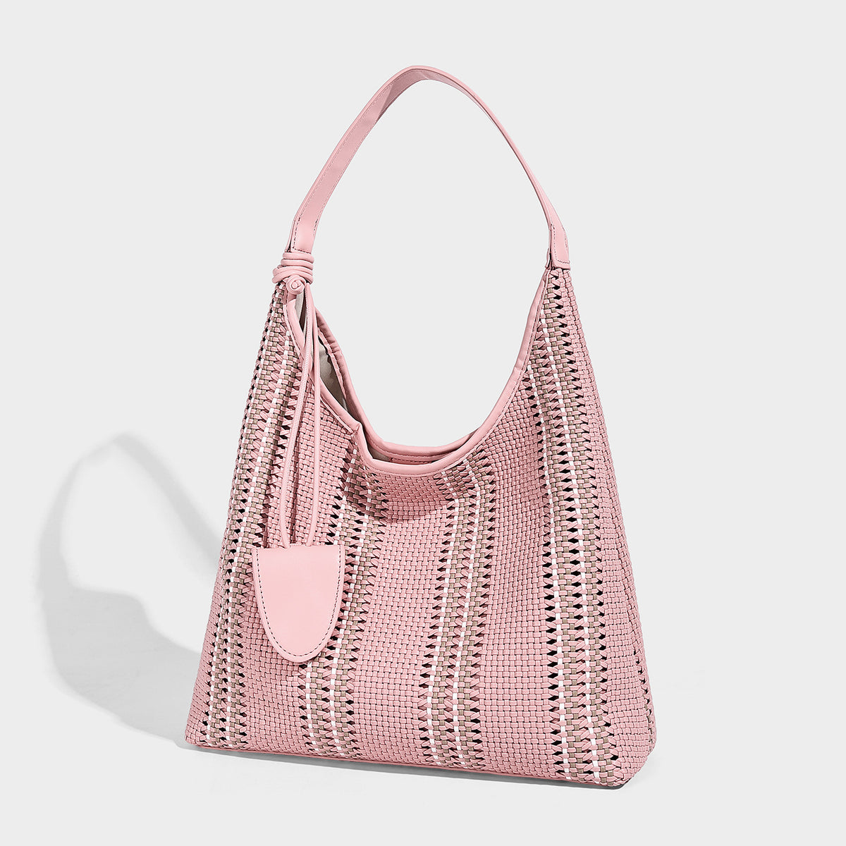 Woven striped slouch shoulder tote bag with knotted strap and attached front flap pouch, front view