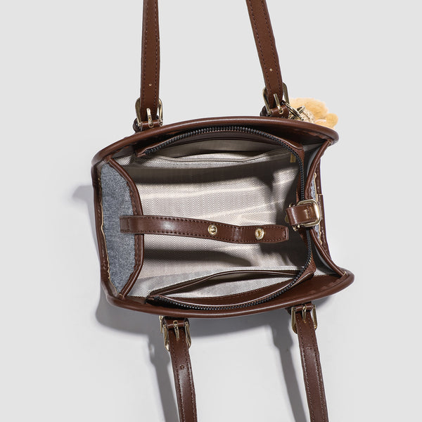 Small structured grey fabric shoulder bag with brown leather-look trim, gold-tone hardware, dual top handles, and detachable