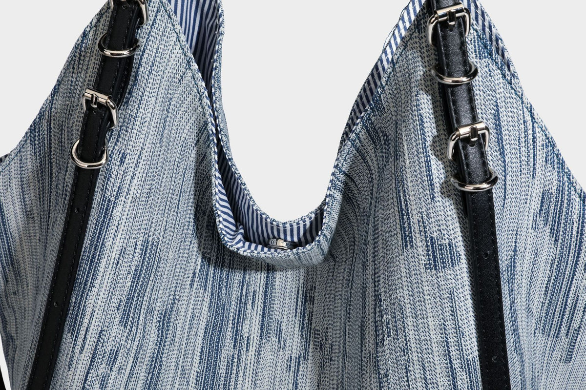 Large slouchy woven-texture shoulder tote bag with slim leather-look straps, side cinch ties, and silver-tone hardware