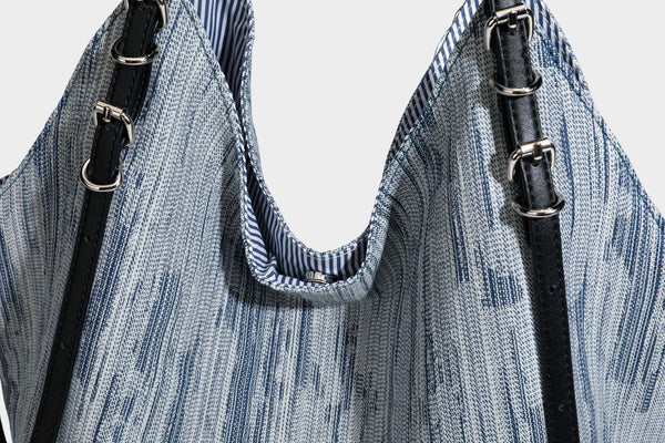Large slouchy woven-texture shoulder tote bag with slim leather-look straps, side cinch ties, and silver-tone hardware