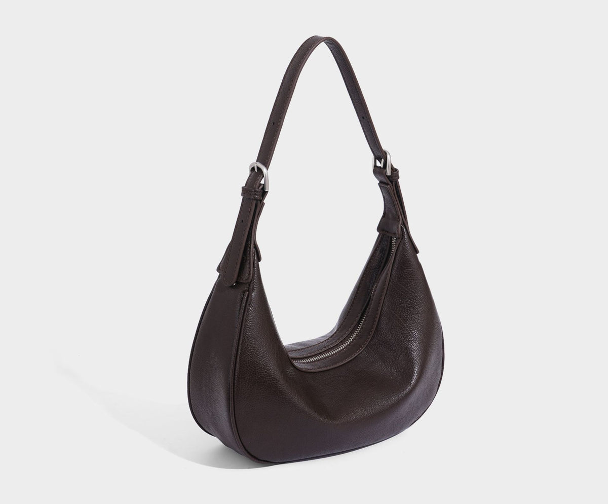 Crescent half-moon shoulder bag in pebbled leather-look finish with adjustable strap and silver-tone hardware, detail view 32