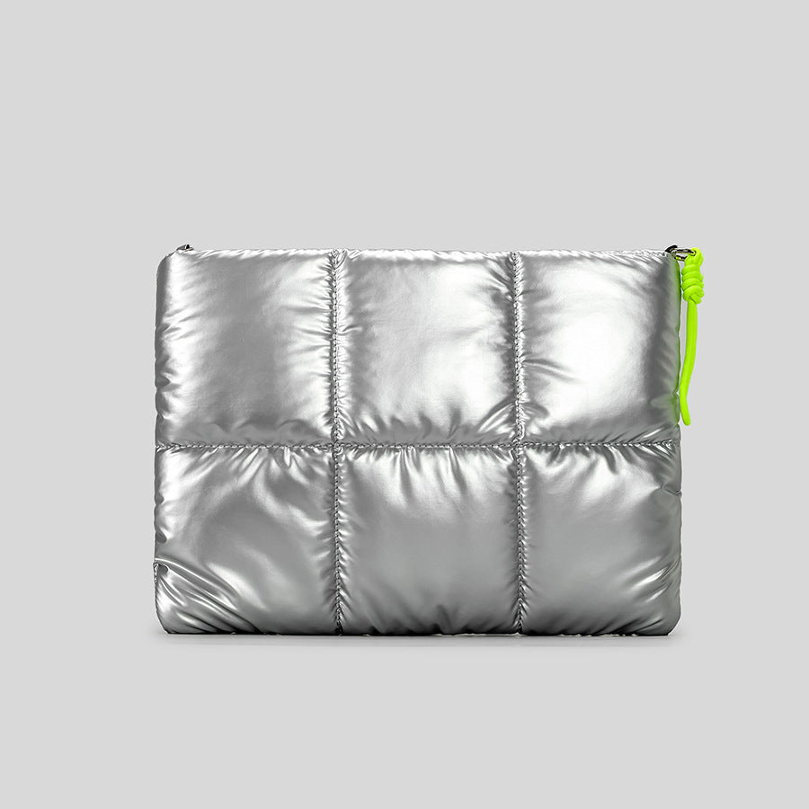 Gesteppte Puffer-Schultertasche in hochglänzendem Metallic-Silber mit neonfarbenem Kordel-Zipperanhänger und gepolstertem, geknotetem Trageriemen, Detailansicht 2