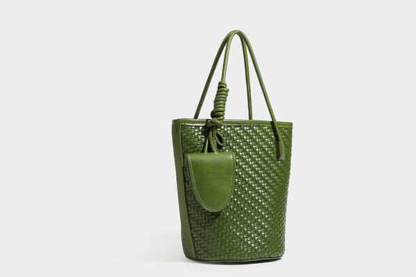 Structured woven-texture leather-look bucket bag in brown with knotted top handles, small front flap pouch, and adjustable