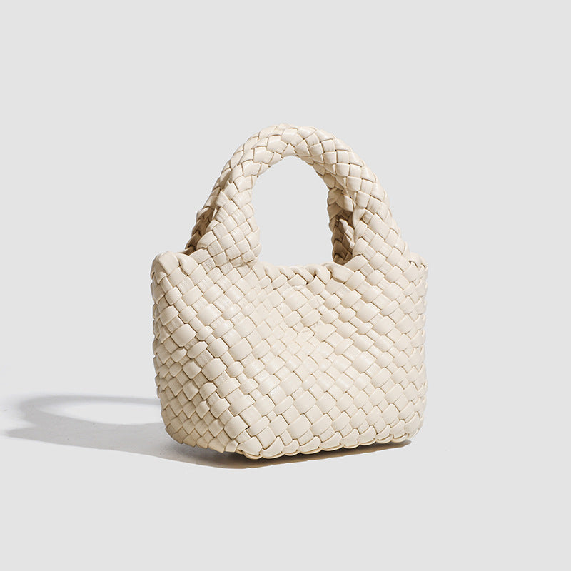 Mini woven basket-weave tote bag with rounded top handles and detachable silver chain strap, detail view 2