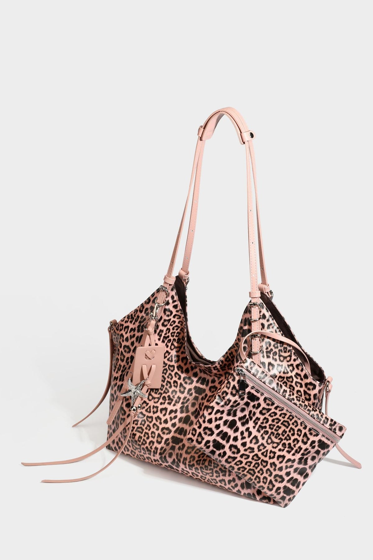 Large leopard print shoulder tote bag with glossy finish, long double straps, front zip pocket, silver-tone hardware, and