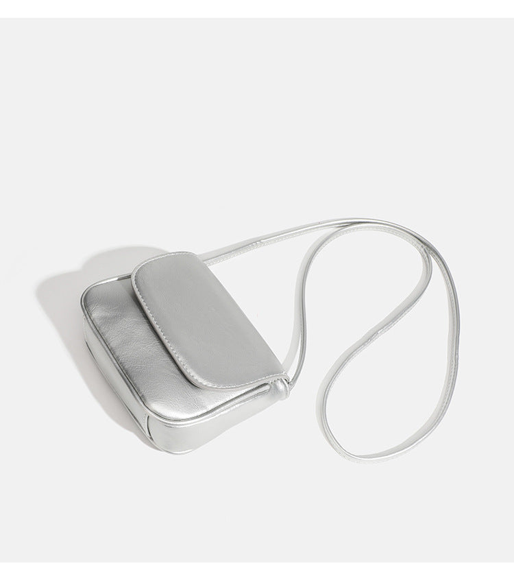 Compact rounded rectangular flap crossbody bag with glossy leather-look finish and long shoulder strap, detail view 16