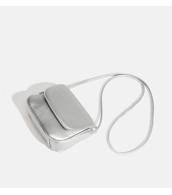 Compact rounded rectangular flap crossbody bag with glossy leather-look finish and long shoulder strap, detail view 16