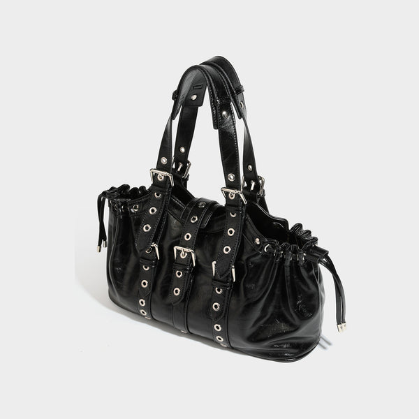 Large black glossy leather-look tote bag with silver buckle straps, eyelet grommet panels, drawstring side gathers, and