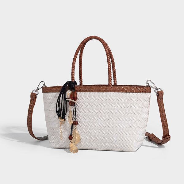 Structured chevron woven leather-look tote bag with braided top handles, gold feather charm, and adjustable shoulder strap