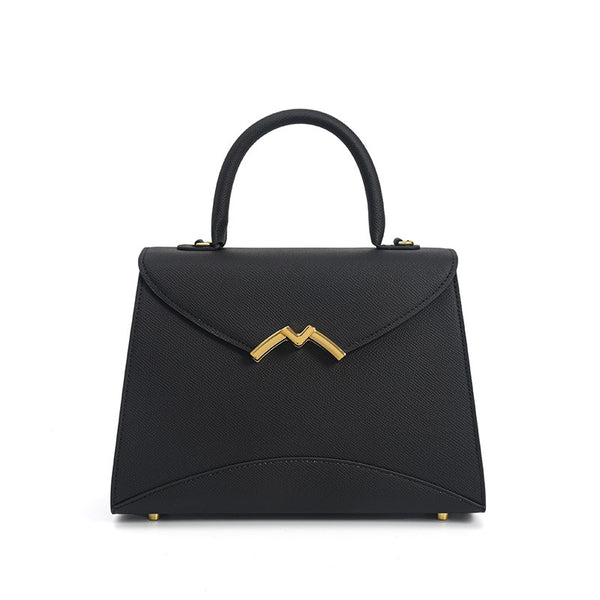 Structured trapezoid top-handle satchel in golden brown cross-grain textured finish with gold M-shaped clasp hardware and