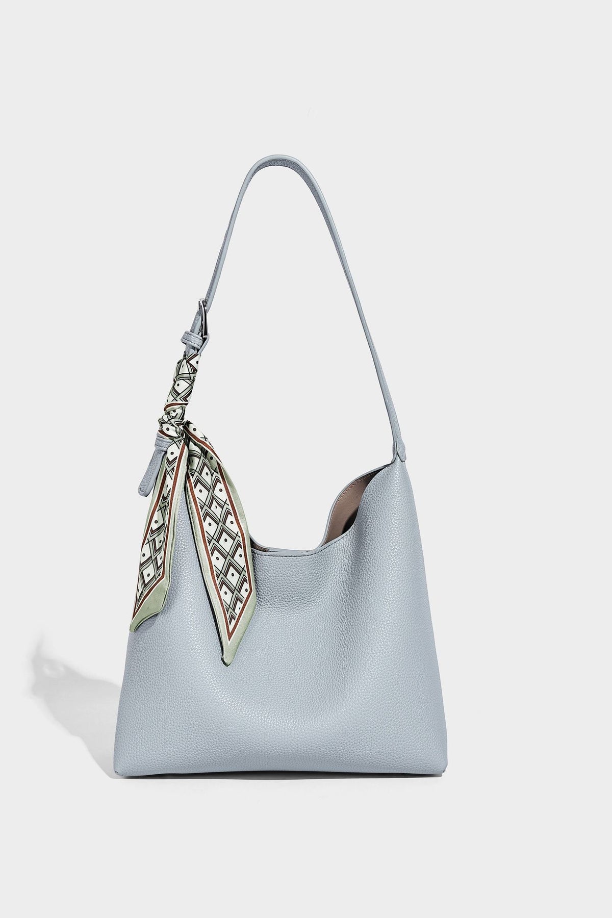 Soft slouchy hobo shoulder bag in pebbled matte finish with slim strap, silver-tone ring hardware, and knotted printed scarf