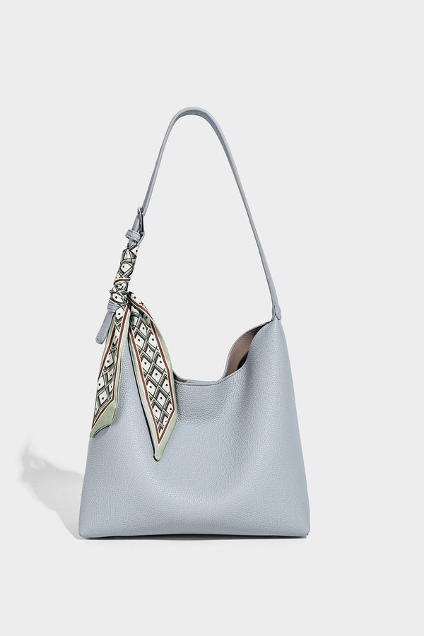Soft slouchy hobo shoulder bag in pebbled matte finish with slim strap, silver-tone ring hardware, and knotted printed scarf