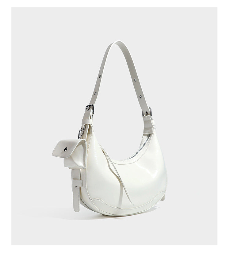 Glossy leather-look crescent hobo shoulder bag with dark contrast trim, silver-tone hardware, and attached mini flap pouch