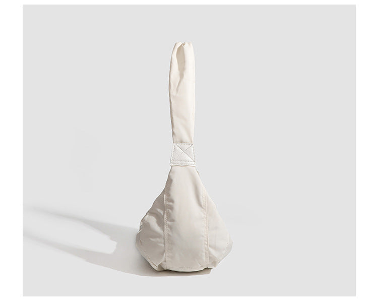 Large crescent sling shoulder bag in gathered fabric with zip closure and adjustable strap, detail view 10