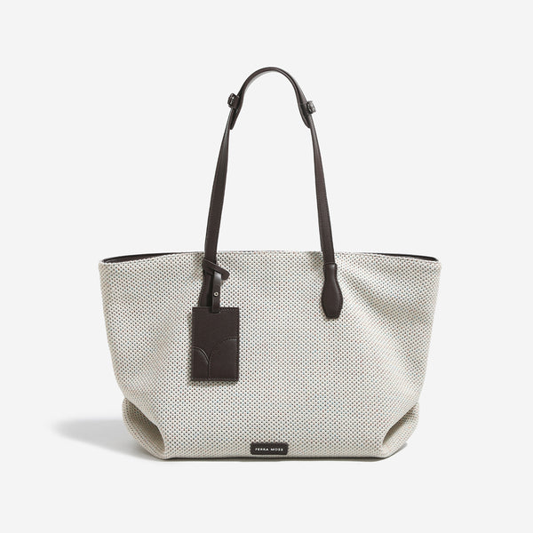 Off-white speckled woven tote bag with dark brown leather-look shoulder straps, zip closure, and hanging rectangular tag