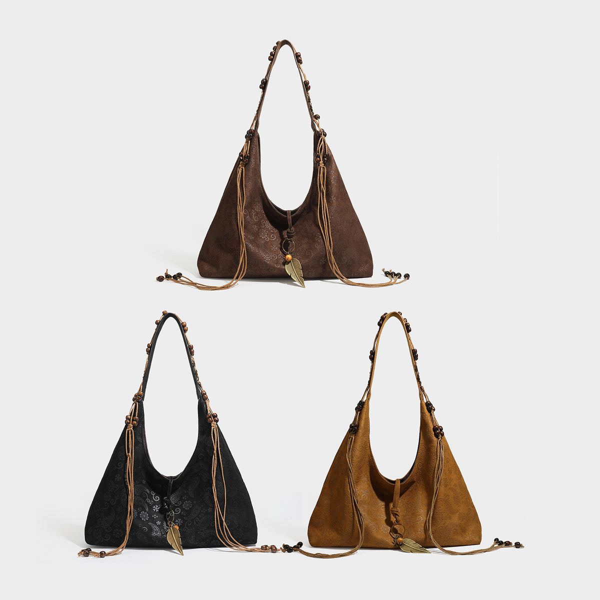 Slouchy boho hobo shoulder bag in embossed brown suede-look finish with beaded strap, cord tassels, and brass-tone leaf