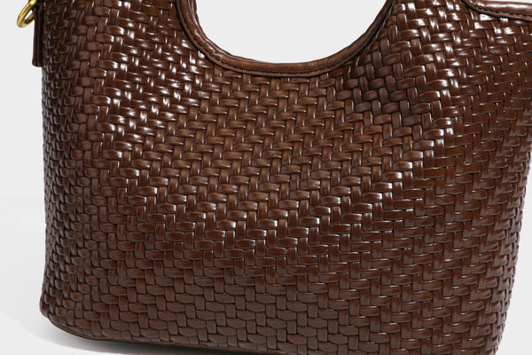 Woven leather-look tote bag in mocha brown with knotted top handle, front flap pocket, and detachable crossbody strap with