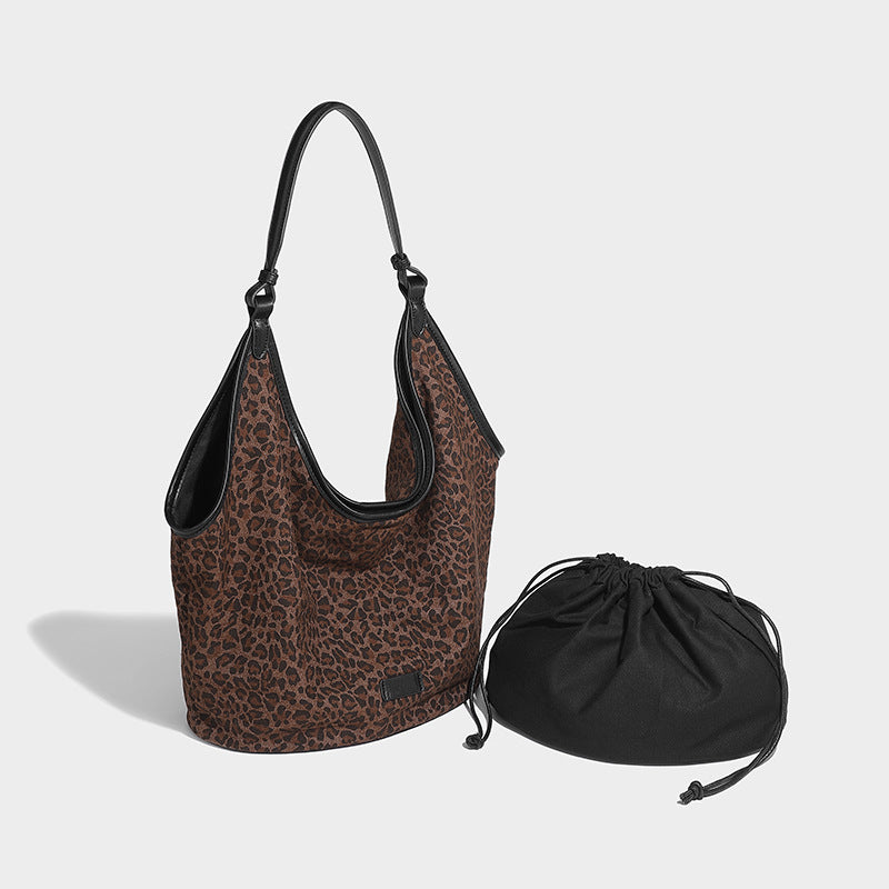 Slouchy brown leopard jacquard hobo tote bag with black leather-look trim and single shoulder strap, shown with black, detail