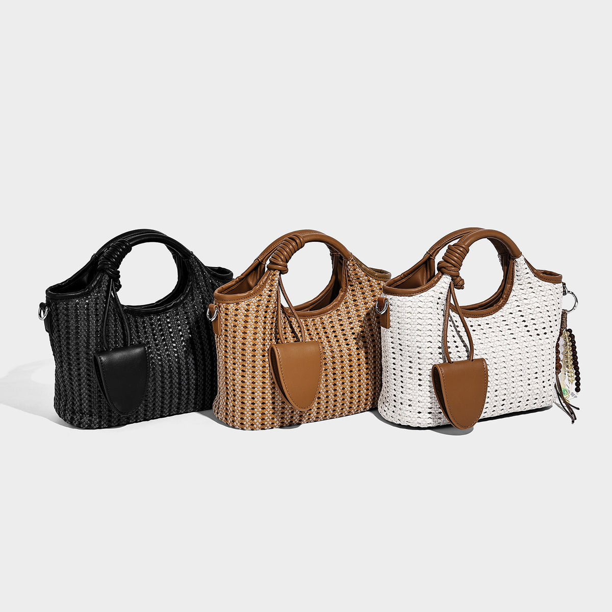 Small structured woven tote crossbody bag with ring top handle, leather-look brown trim, front patch pocket, and detachable