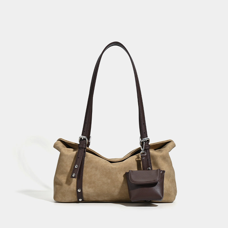 Large slouchy hobo shoulder bag in tan with dark brown leather-look trim, paired shoulder straps, silver hardware, and, front