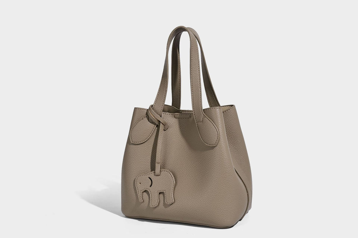 Compact pebbled bucket tote bag with elephant charm, twin top handles, and detachable crossbody strap, detail view 33