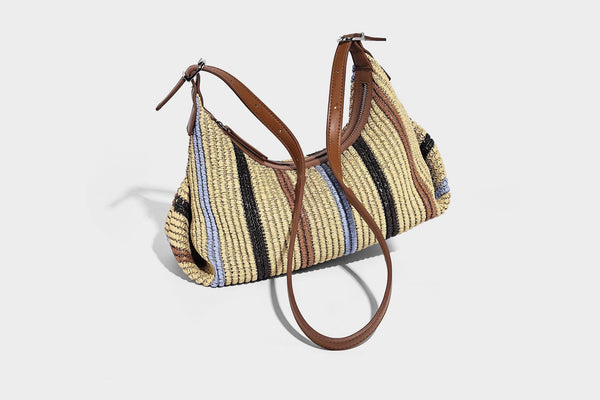 Slouchy woven straw hobo shoulder bag with beige, black, brown, and blue vertical stripes and brown leather-look trim, detail