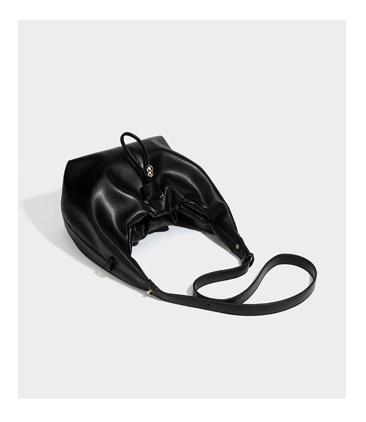 Slouchy hobo bag with smooth leather-look finish, drawstring cinch closure, and gold-tone bead hardware, detail view 14