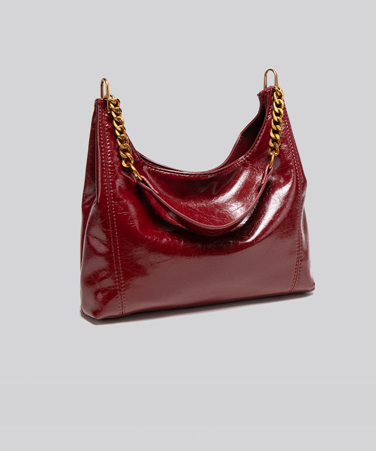 Glossy leather-look hobo shoulder bag with gold-tone chain-and-leather strap in deep burgundy red, detail view 14