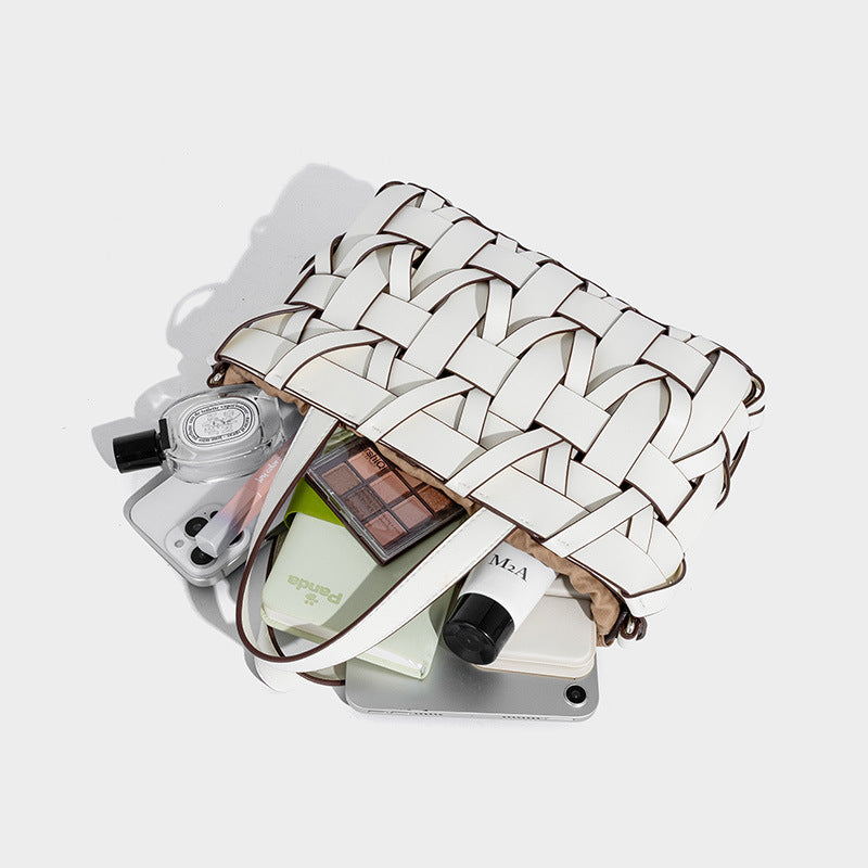 Structured woven basket tote handbag with contrasting dark trim, double top handles, detachable shoulder strap, and